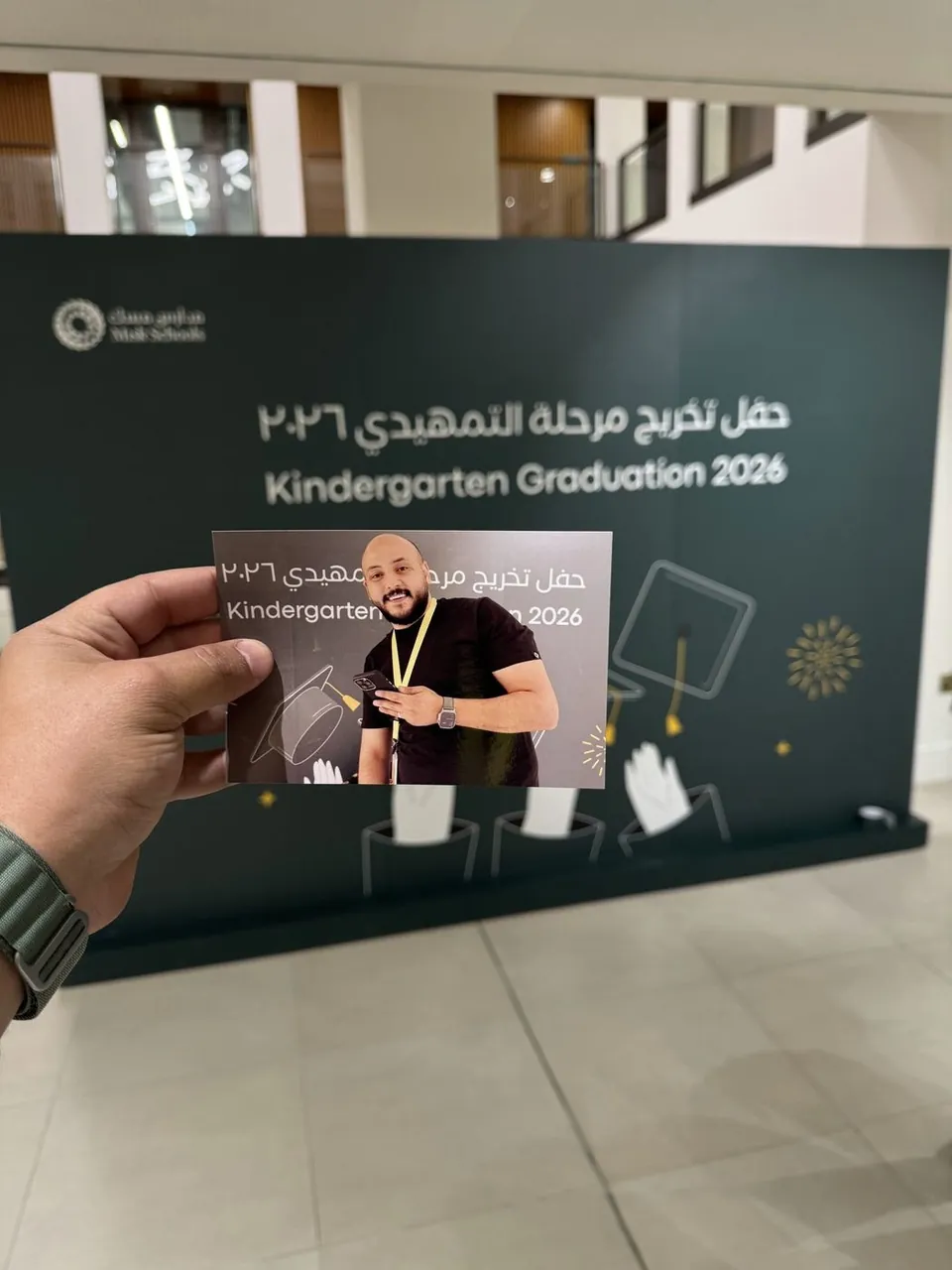 Instant graduation print in front of the Misk Schools backdrop